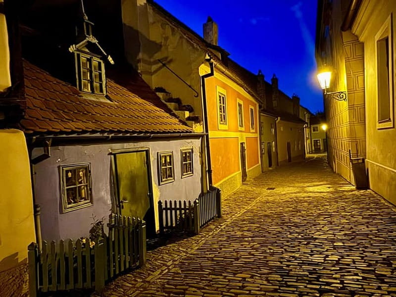 Prague: Night Walk through Prague Castle with City Views - Prague Castle at night, with the clock ticking