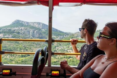 Split: Historical Tour of Salona, Klis Fortress and Trogir - Getting on the open-top red bus near Apodos Travel Agency